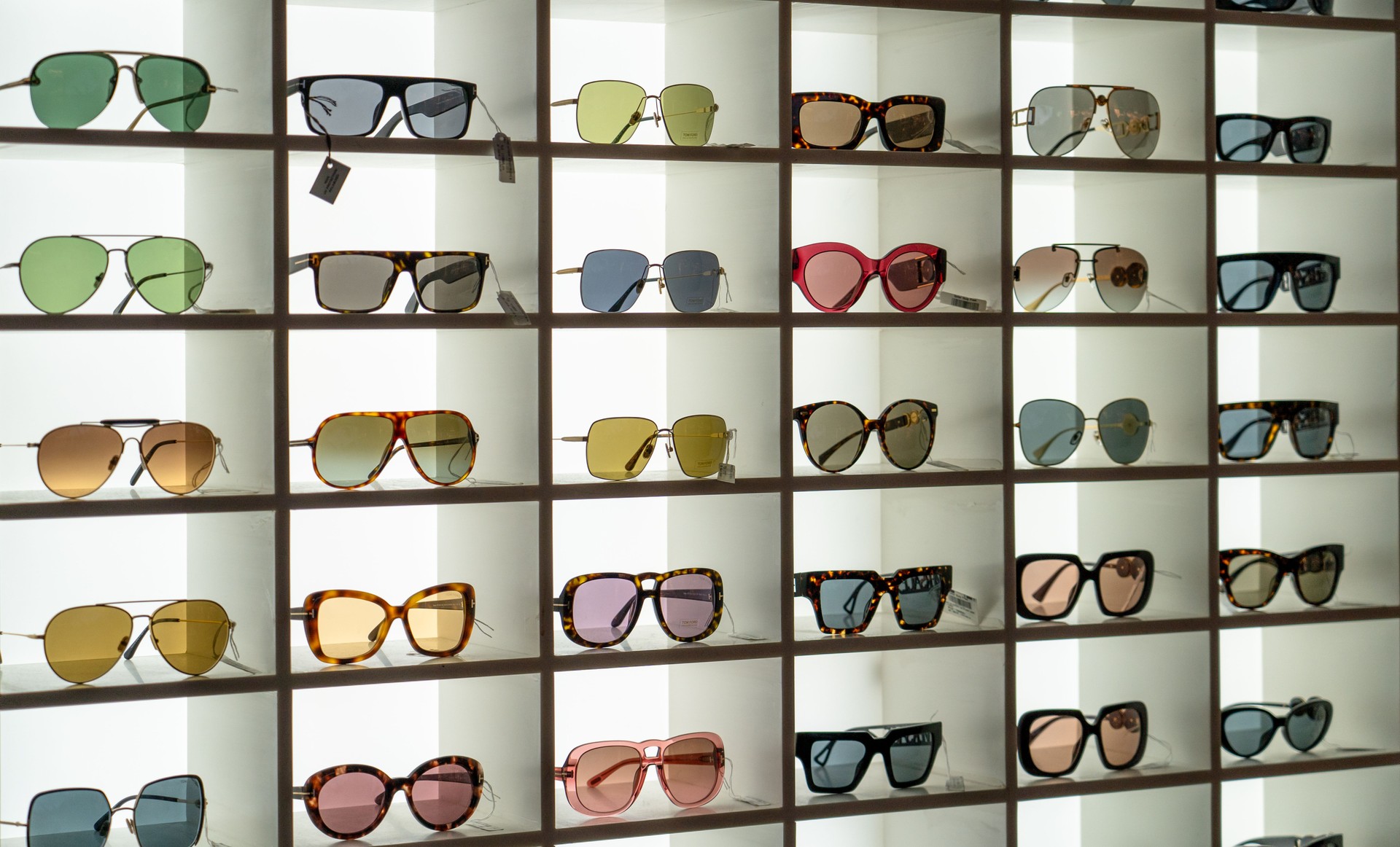 Display rack full of various sunglasses.