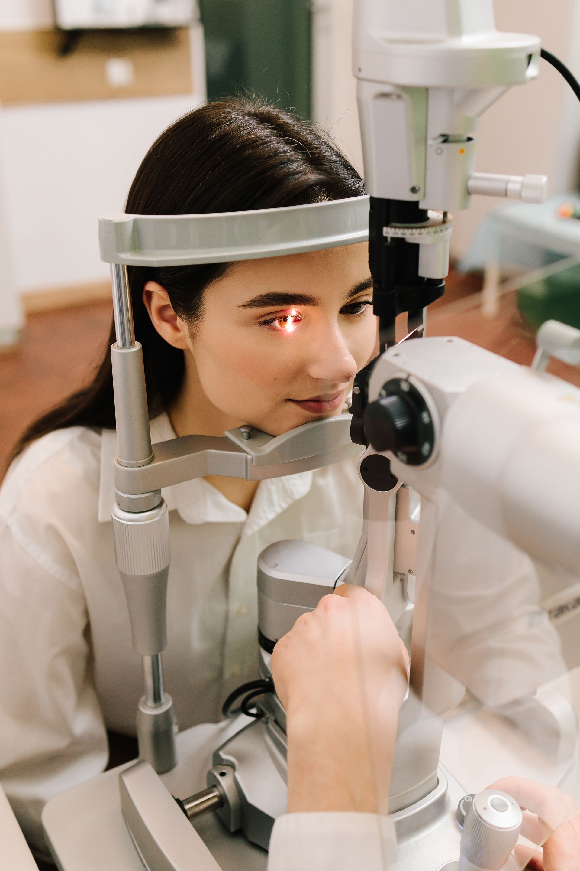 Ophthalmology procedure with slit lamp for eye and cornea checkup. Girl is visiting ophthalmologist for eyes examination.