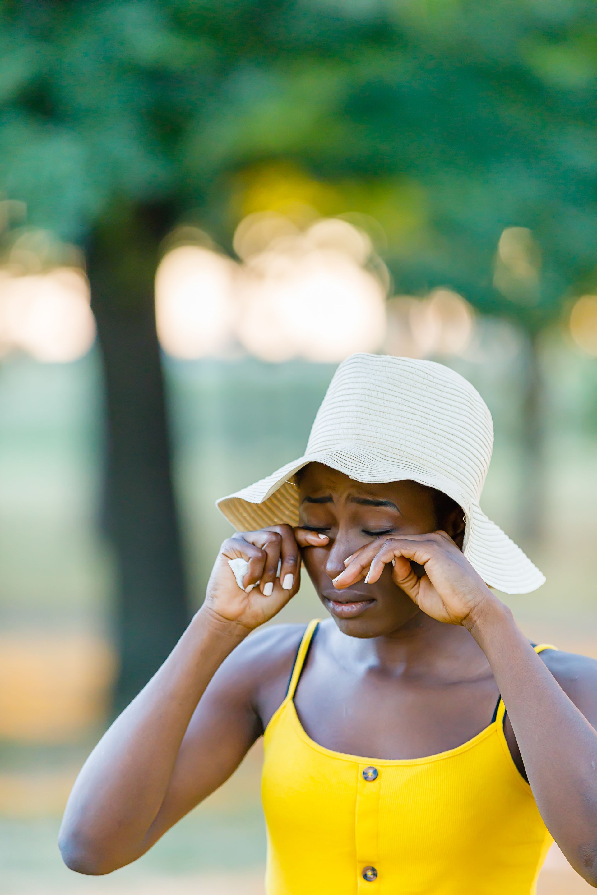 Beautiful African-American Woman is Having Allergy Problems Outside in Nature.