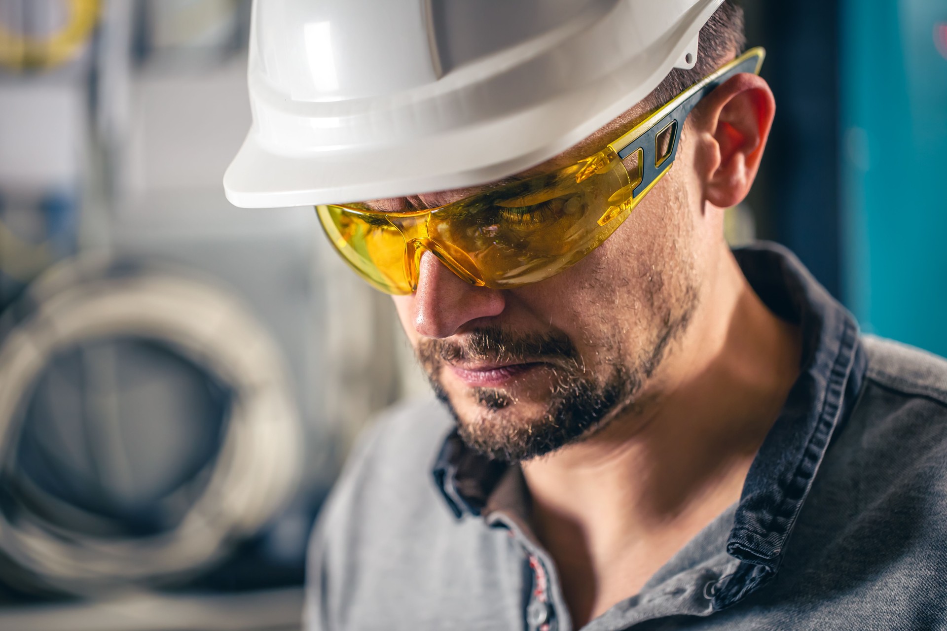Man, an electrical technician working in a switchboard with fuses.
